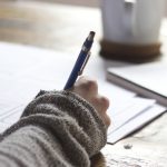 Student studying ACT Science section with graphs and data tables