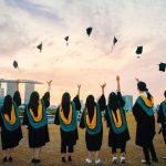 College students celebrating acceptance letters before May 1 Decision Day
