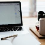 Student following a May SAT study plan with notes and laptop on a desk