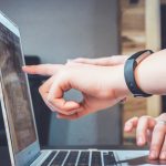 Student wearing headphones practicing TOEFL Speaking on a laptop in preparation for the 2026 exam format