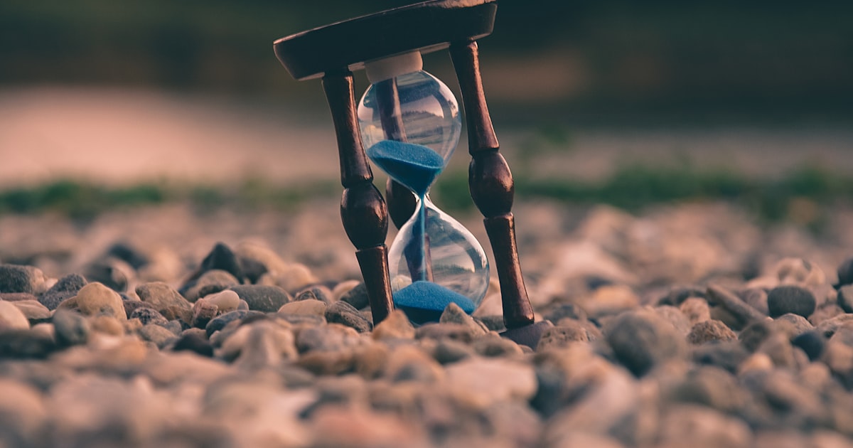 A clock beside study materials representing ACT section time management