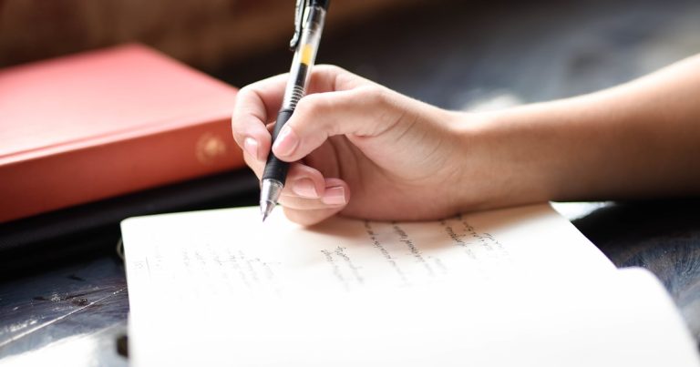 Student writing during an ACT test, deciding whether to take the optional Science section
