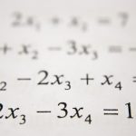 Student using a graphing calculator while studying math problems for the Digital SAT