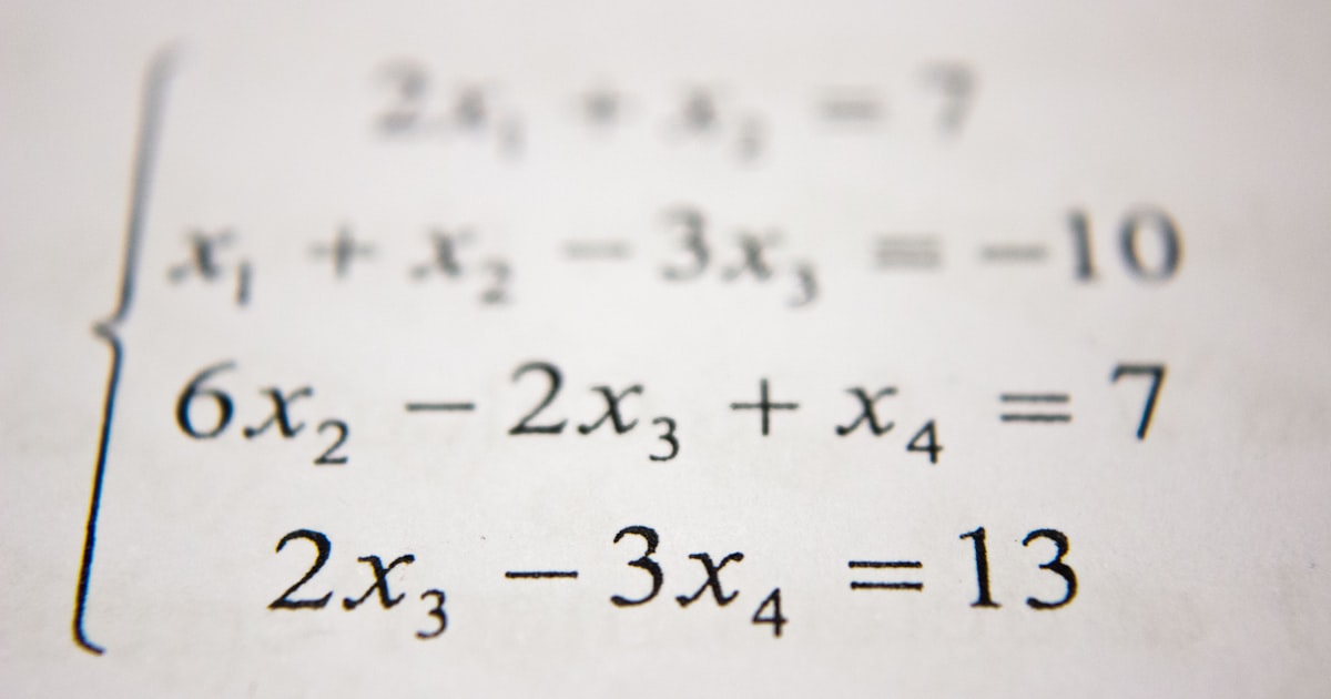 Student using a graphing calculator while studying math problems for the Digital SAT