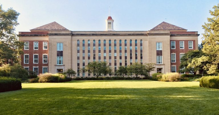 University campus building with students, representing early decision and early action college application planning