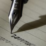 Fountain pen writing a letter on paper, representing college recommendation letters