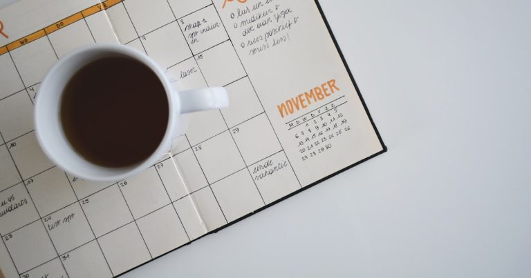 A wall calendar and notebook on a desk, marking application deadlines for TOEFL and IELTS score reporting