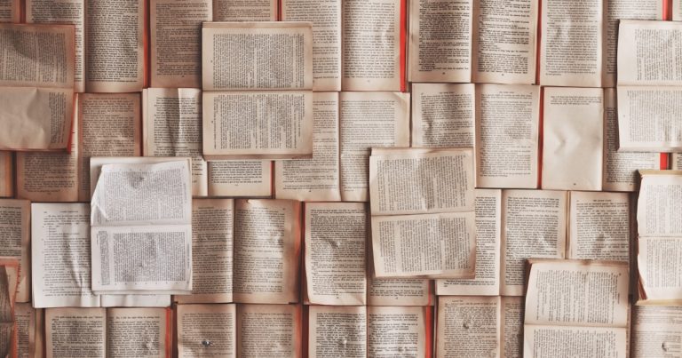 Wall of open book pages, representing TOEFL Reading passages, vocabulary and main idea practice