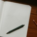 An open notebook with a pen, set up for reviewing English grammar and punctuation rules