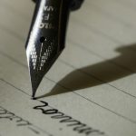 A close-up of a vintage typewriter with a sheet of paper, symbolizing the mechanics of grammar and sentence construction