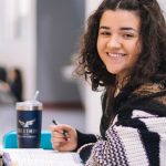 A high school student working through Digital SAT math practice problems at a desk
