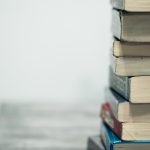 Stack of well-worn books symbolizing close reading and word study for Digital SAT vocabulary prep