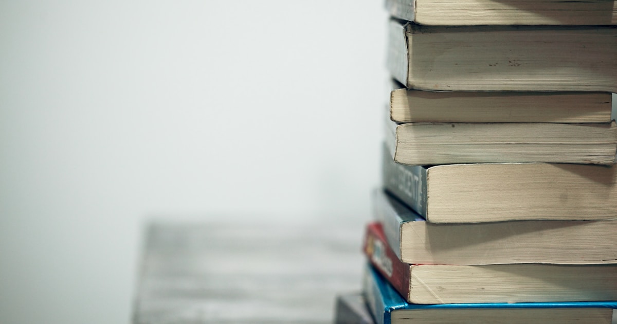 Stack of well-worn books symbolizing close reading and word study for Digital SAT vocabulary prep